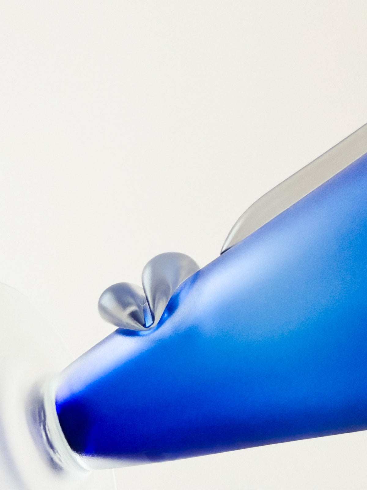 A closeup showing a handblown cobalt blue glass face vase showing nose and mouth. Home Decor. Vintage. Collectible.