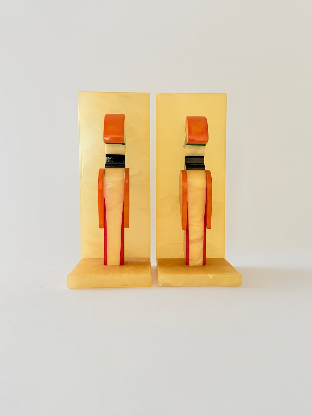 Back View of a pair of colorful alabaster bookends shaped like stylized birds set against a plain white background. Home Decor. Vintage. Collectible. 