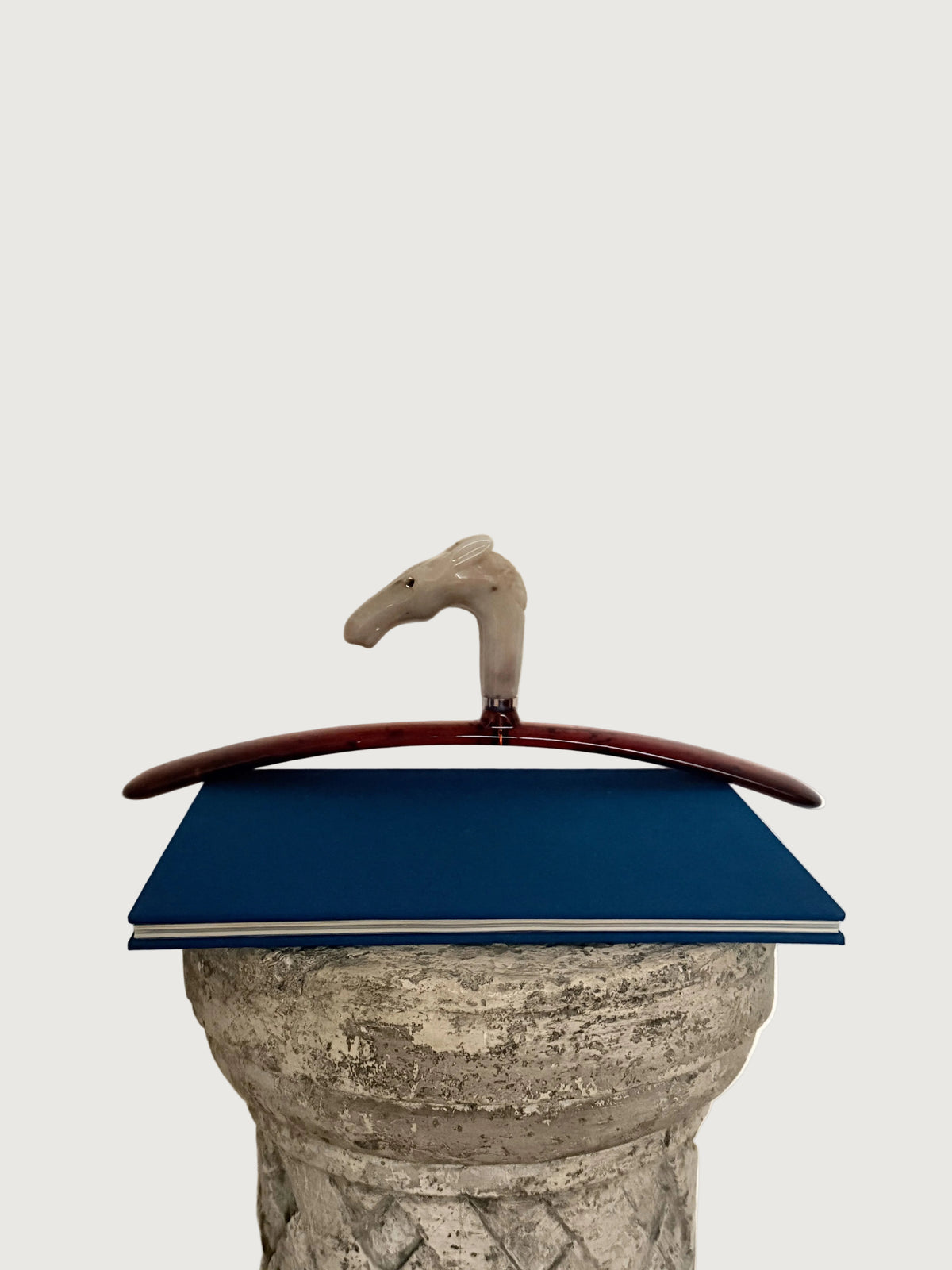 Italian Cream Horse Head  Hanger styled on pedestal over bleu book