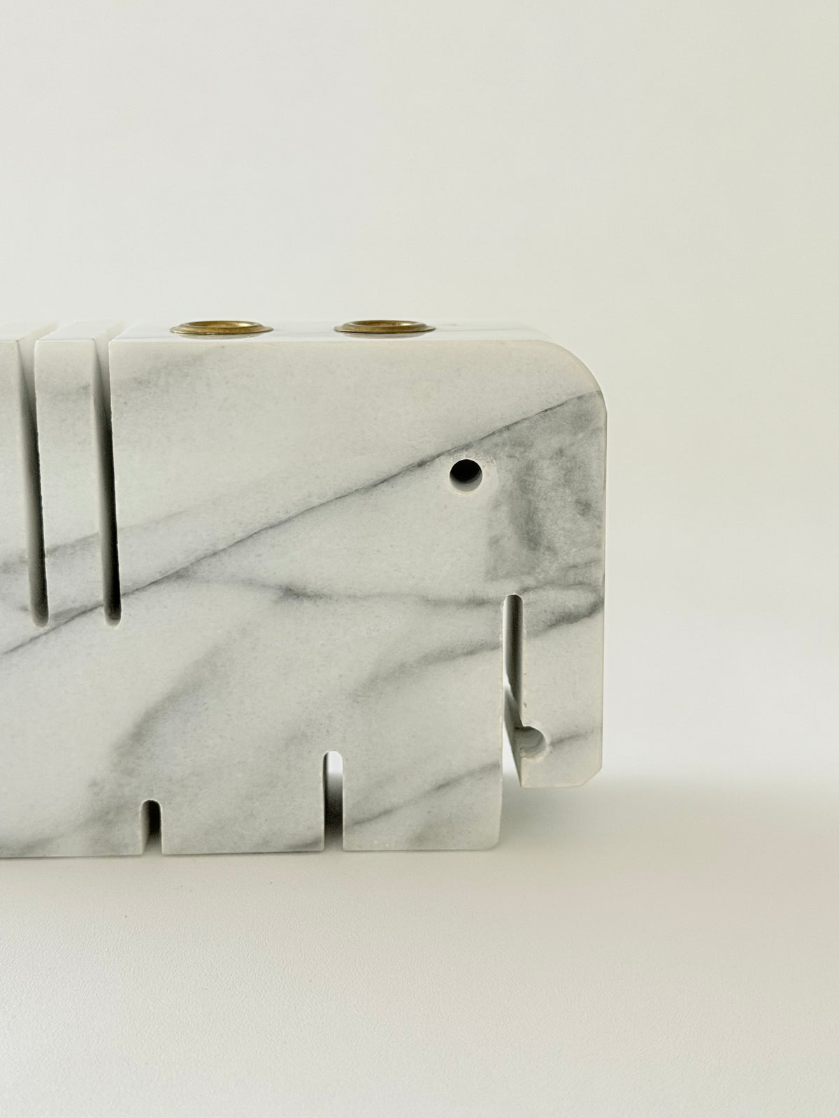 Detail shot , front view of white and gray marble elephant penholder.