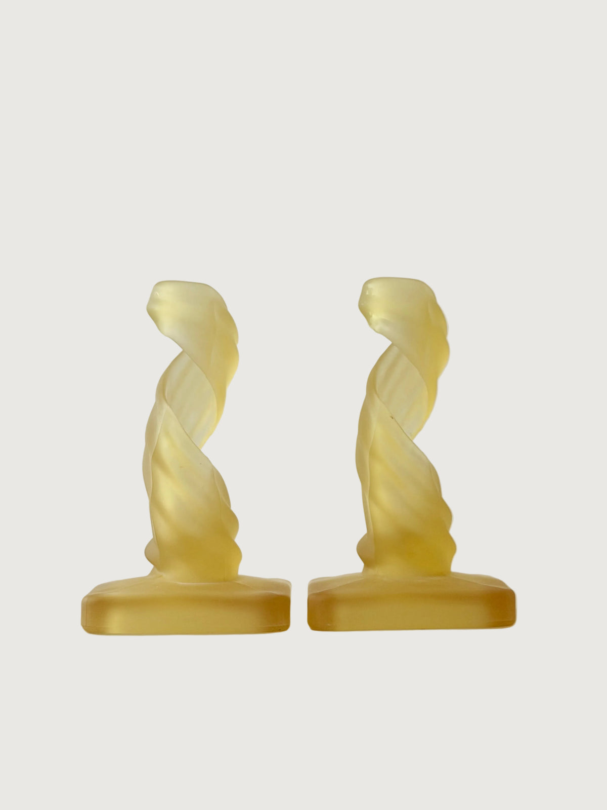 A pair of frosted glass sculptural spiral candleholders.